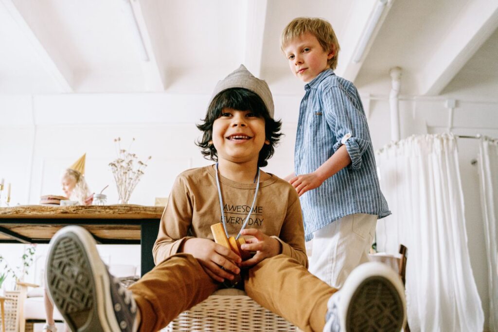 Two happy children enjoying playtime indoors, showcasing friendship and fun.